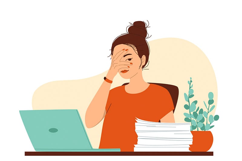 Ilustração de menina na frente do computador com uma das mãos sobre o rosto cobrindo um dos olhos para ilustrar artigo sobre o que faz a menstruação atrasar