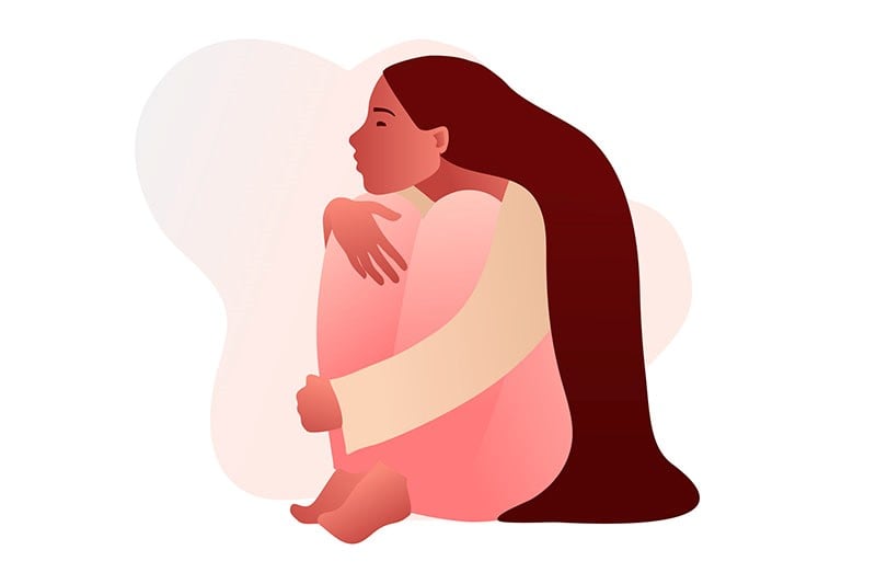 desenho de uma menina sentada se abraçando